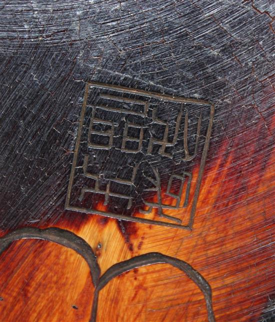 A Chinese mammoth ivory carving of a seated figure of Li Bai, holding a book, 16.5cm, wood stand